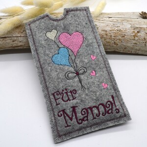 May include: A gray felt card with a pink, blue, and white heart balloon design. The card says "F&uuml;r Mama!" in burgundy embroidery.
