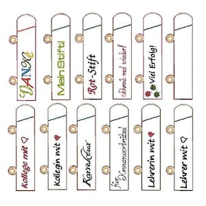 May include: A collection of embroidered bookmarks with various German phrases and designs. The bookmarks are rectangular with rounded tops and feature text like "DANKE", "Mein Stift!", and "Viel Erfolg!" in colorful stitching. Each bookmark has a small, decorative gold-colored element.