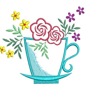 May include: A blue teacup with a white interior and a floral design. The flowers are red, pink, and yellow. The teacup has a handle and a saucer.