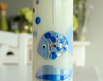 May include: White baptism candle with a blue fish design, silver accents, and the name "Benjamin" and date "12.02.2017" written on the bottom.