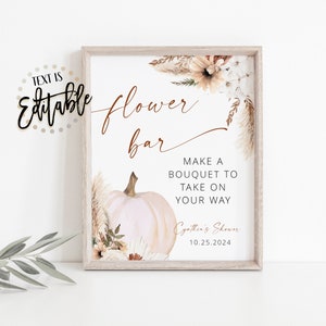 May include: A printable sign for a flower bar with a white pumpkin, pampas grass, and flowers in shades of brown and white. The text reads "flower bar" and "Make a bouquet to take on your way". The sign also includes the text "Cythin's Shower 10.25.2024".