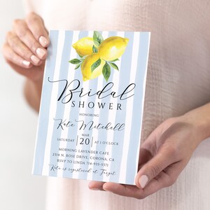 May include: A blue and white striped bridal shower invitation with a watercolor illustration of lemons. The invitation reads "Bridal Shower Honoring Kate Mitchell Saturday Mar 20 at 1 o'clock Morning Lavender Cafe 2314 N. Rose Drive, Corona, CA RSVP to Linda 714-935-5371 Kate is registered at Target"