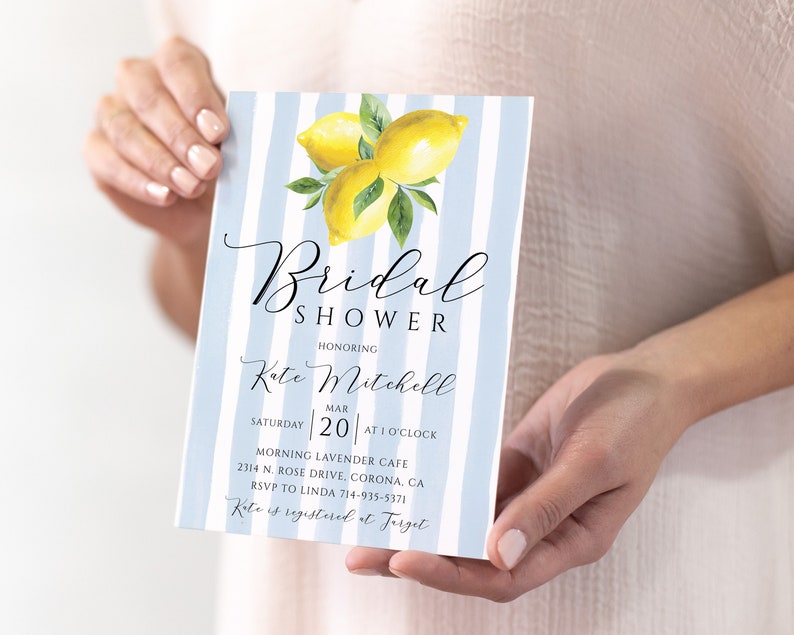 May include: A blue and white striped bridal shower invitation with a watercolor illustration of lemons. The invitation reads "Bridal Shower Honoring Kate Mitchell Saturday Mar 20 at 1 o'clock Morning Lavender Cafe 2314 N. Rose Drive, Corona, CA RSVP to Linda 714-935-5371 Kate is registered at Target"