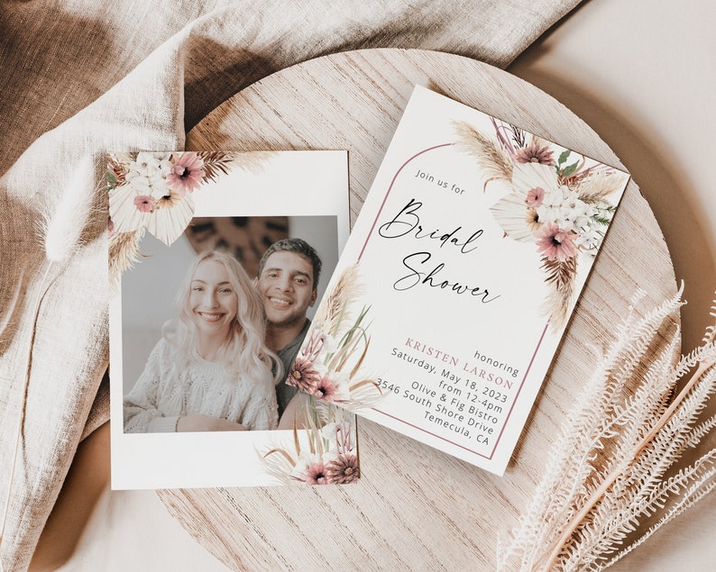 May include: A bridal shower invitation with a floral design featuring pampas grass and pink flowers. The invitation includes the text "Join us for Bridal Shower honoring Kristen Larson Saturday, May 18, 2023 from 12-4pm Olive & Fig Bistro 3546 South Shore Drive Temecula, CA"
