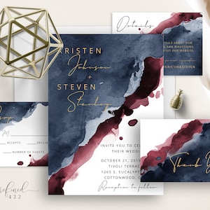 May include: Wedding invitation suite with a watercolor background in shades of blue and burgundy. The invitation features the couple's names, "Kristen Johnson + Steven Stanley", and the wedding date, "October 21, 2019". The RSVP card includes a space for guests to indicate their attendance and the number of guests.
