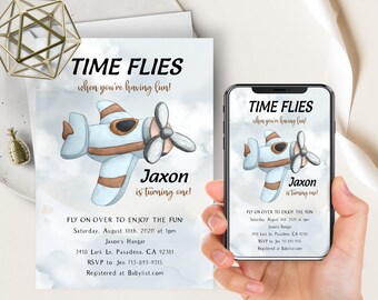 May include: A blue and brown airplane with a white background. The text "TIME FLIES when you're having fun!" is at the top of the image. The text "Jaxon is turning one!" is below the airplane. The text "FLY ON OVER TO ENJOY THE FUN Saturday, August 18th, 2020 at 1pm Jaxon's Hangar 3418 Lark Ln. Pasadena, CA 92361 RSVP to Jen 713-893-9315 Registered at Babylist.com" is at the bottom of the image.