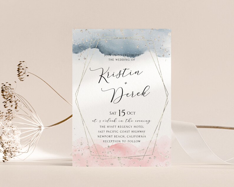 May include: Wedding invitation with a watercolor background in shades of blue and pink with gold glitter accents. The invitation features the names Kristin and Derek and the date Saturday, October 15th. The text reads "Join us to celebrate the wedding of Kristin + Derek, Sat 15 Oct at 5 o'clock in the evening, The Hyatt Regency Hotel, 5427 Pacific Coast Highway, Newport Beach, California, Reception to follow."