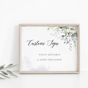 May include: A printable sign with the text "Custom Sign" in a cursive font. The sign is decorated with a watercolor floral design in shades of green and blue. The text "Fully Editable" and "6 Sizes Included" is also included on the sign.