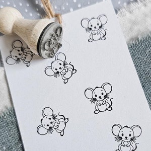 Könnte beinhalten: Eine weiße Karte mit neun schwarzen und weißen Maus-Illustrationen. Die Karte liegt auf einer grauen und weißen gemusterten Oberfläche.