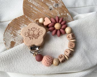 Personalized pacifier chain for girls with flower and heart in peach and red as a gift for a newborn