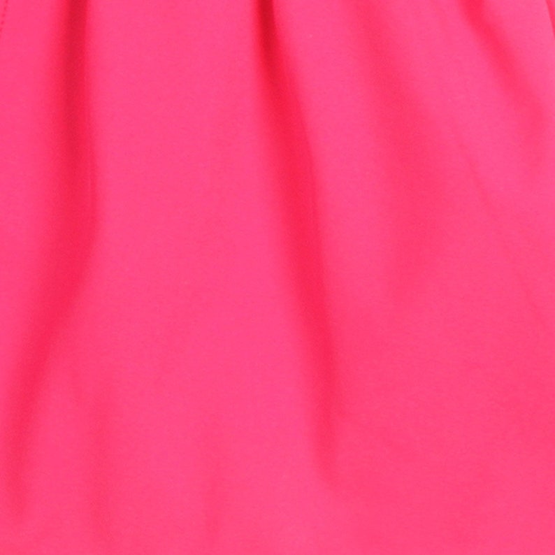 May include: A bright pink fabric with a smooth texture.