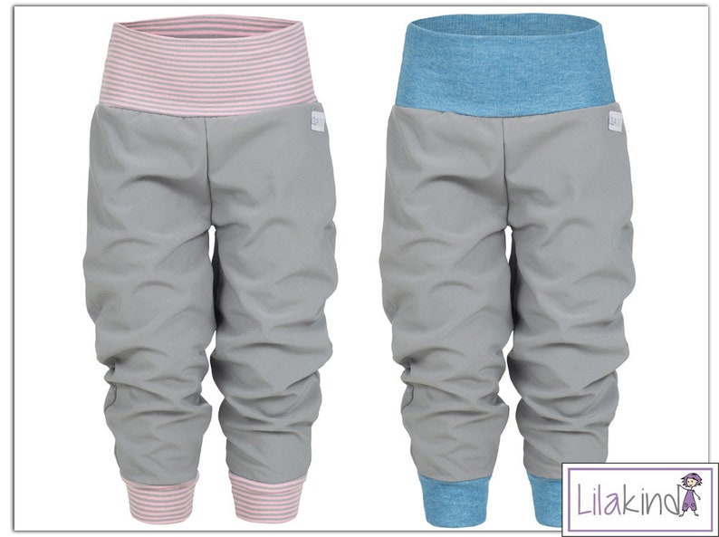 May include: Two pairs of gray pants with elastic waistbands. One pair has a pink striped waistband and the other has a blue striped waistband.