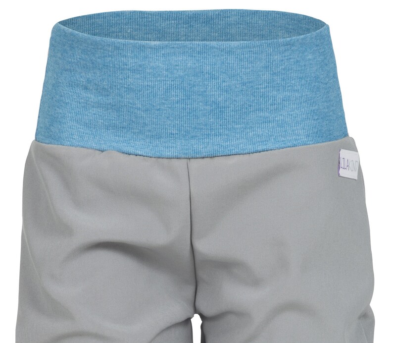 May include: Gray shorts with a light blue elastic waistband. The shorts have a small white tag with the text "124.00" on the right side.
