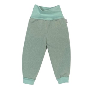 May include: A pair of light green trousers with a wide elastic waistband. The trousers have a cuffed hem and are made of a soft, comfortable fabric.