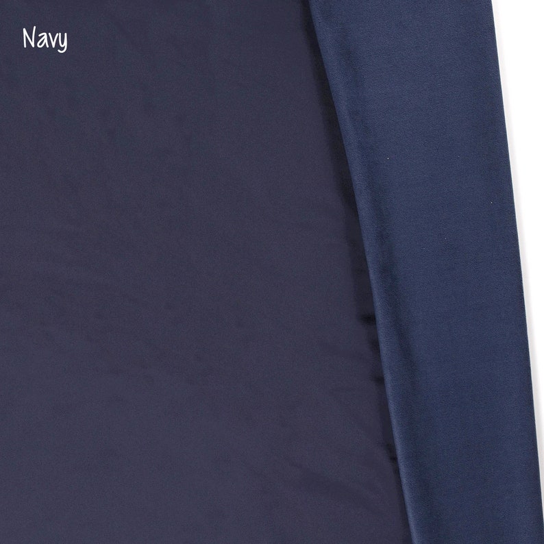 May include: A close-up of a navy blue fabric. The fabric is smooth and has a slight sheen. The text "Navy" is visible in the top left corner of the image.