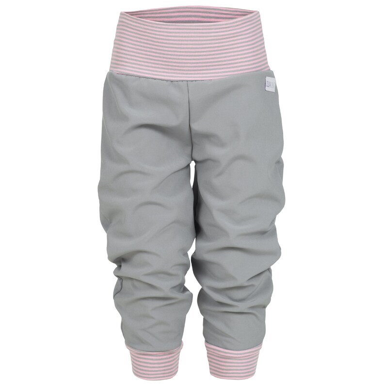 May include: Gray pants with pink striped waistband and cuffs. The pants are made of a soft, stretchy material and have a relaxed fit.