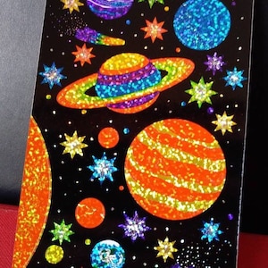 May include: A set of three ceramic mugs with a speckled, matte finish. The mugs are in shades of cream, light gray, and dark gray. Each mug has a simple, minimalist design and a rounded handle.