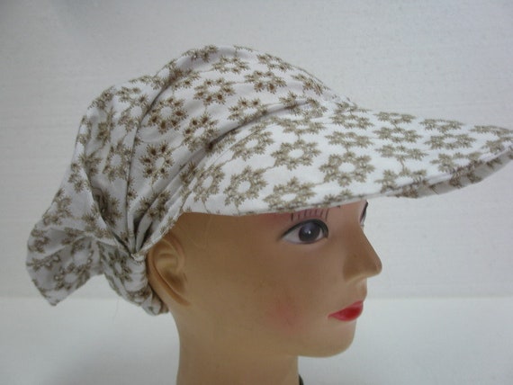 Hairband with shield made of perforated fabric flowers