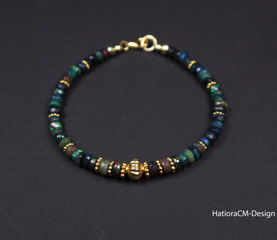 Bracelet with black ethiopian opals, with intermediate parts and carabiner closure in gold-plated silver (925)