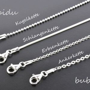 May include: Four different types of silver chains with clasps: a ball chain, a snake chain, a curb chain, and an anchor chain. The chains are labeled in German: Kugelkette, Schlangenkette, Erbsenkette, and Ankerkette.