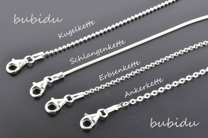 May include: Four different types of silver chains with clasps: a ball chain, a snake chain, a curb chain, and an anchor chain. The chains are labeled in German: Kugelkette, Schlangenkette, Erbsenkette, and Ankerkette.