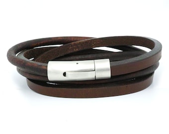 May include: A brown leather wrap bracelet with a silver magnetic clasp.