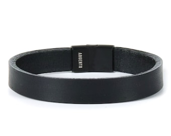 May include: A black leather bracelet with a black metal clasp. The clasp has the word "ARGENTO" engraved on it.