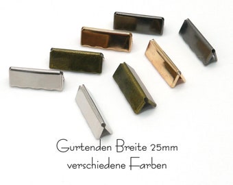 May include: Assortment of metal belt strap ends in various colors, including silver, gold, bronze, and black. The strap ends are 25mm wide. "Gurtenden Breite 25mm verschiedene Farben" is written below the strap ends.