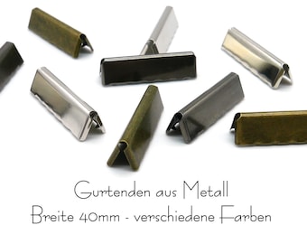 May include: Assortment of metal belt ends in various finishes, including silver, black, and brass. Each end measures 40mm wide.