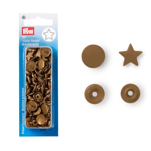 May include: A pack of 30 bronze-coloured 'Color Snaps' press fasteners. The image shows round and star-shaped snap fasteners. There are also two separate snaps, one round and one star-shaped, and two snap bases.