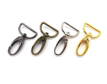 May include: Four metal swivel clasps in different finishes: silver, antique brass, nickel, and gold. These clasps are great for attaching to bags, keychains, or other accessories.