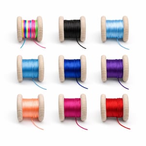 May include: Nine wooden spools wrapped with colourful cord. The top row features a multi-coloured neon striped cord, a solid black cord, and a light blue cord. The middle row has a medium blue, a royal blue, and a purple cord. The bottom row shows an orange, a magenta, and a red cord.