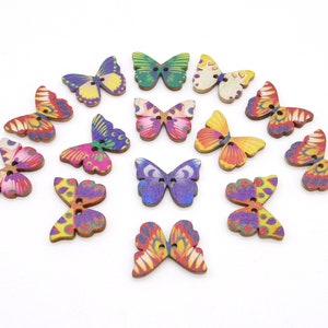 May include: Assortment of 15 wooden butterfly buttons with colorful painted designs. The buttons are approximately 2 cm in size and have two holes for sewing.