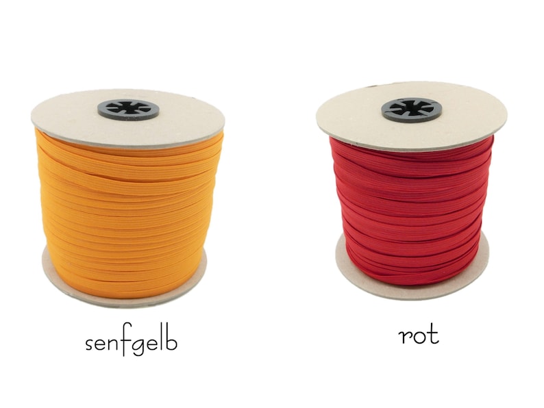 May include: Two spools of elastic cord, one orange and one red. The spools are labeled "senfgelb" and "rot".