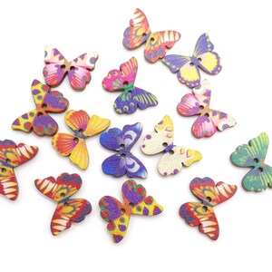 May include: Assortment of colorful wooden butterfly buttons with painted designs. The buttons have two holes each and are perfect for crafting projects.
