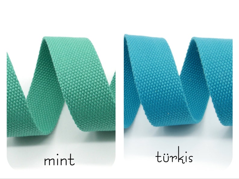 May include: Two rolls of woven cotton webbing, one in mint green and one in turquoise blue. The webbing is coiled and the ends are visible.
