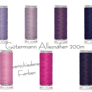 May include: Assortment of Gütermann Allesnäher 200m thread spools in various colours, including lavender, light purple, dark purple, navy blue, pink, and fuchsia. Each spool is 200 metres long.