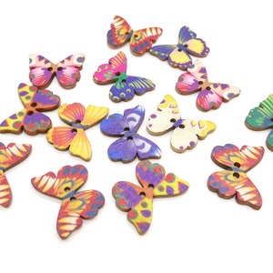 May include: Assortment of colorful wooden butterfly buttons with two holes each. The buttons feature various butterfly designs with vibrant colors like purple, pink, yellow, green, and orange.