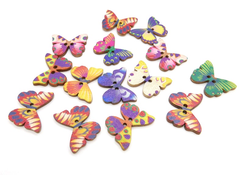 May include: Assortment of colorful wooden butterfly buttons with two holes each. The buttons feature various butterfly designs with vibrant colors like purple, pink, yellow, green, and orange.