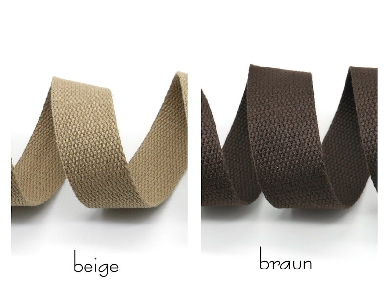 May include: Two rolls of woven cotton webbing, one beige and one brown. The webbing is textured and has a subtle sheen.