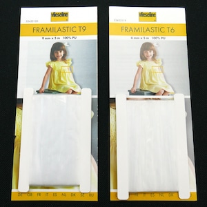 Könnte beinhalten: Zwei Packungen Framilastic T9 und T6, ein weißes elastisches Band. Die T9-Packung ist 9 mm x 5 m, und die T6-Packung ist 6 mm x 5 m. Beide Packungen zeigen ein Bild eines Mädchens in einem gelben Kleid.