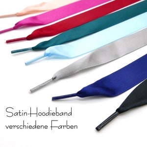 Könnte beinhalten: Ein Satz Satin-Schnürsenkel in verschiedenen Farben, darunter Pink, Rot, Türkis, Hellblau, Grau, Dunkelblau und Schwarz. Die Schnürsenkel sind in einer Reihe angeordnet, wobei die Spitzen der Schnürsenkel nach rechts zeigen. Der Text "Satin-Hoodie-band verschiedene Farben" ist am unteren Rand des Bildes sichtbar.
