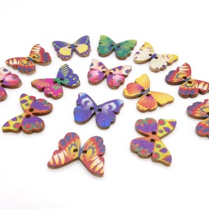 May include: Assortment of wooden butterfly buttons in various colors and patterns, including purple, pink, yellow, orange, green, and blue.