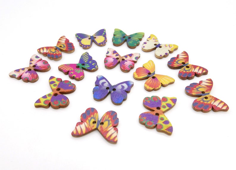 May include: Assortment of wooden butterfly buttons in various colors and patterns, including purple, pink, yellow, orange, green, and blue.