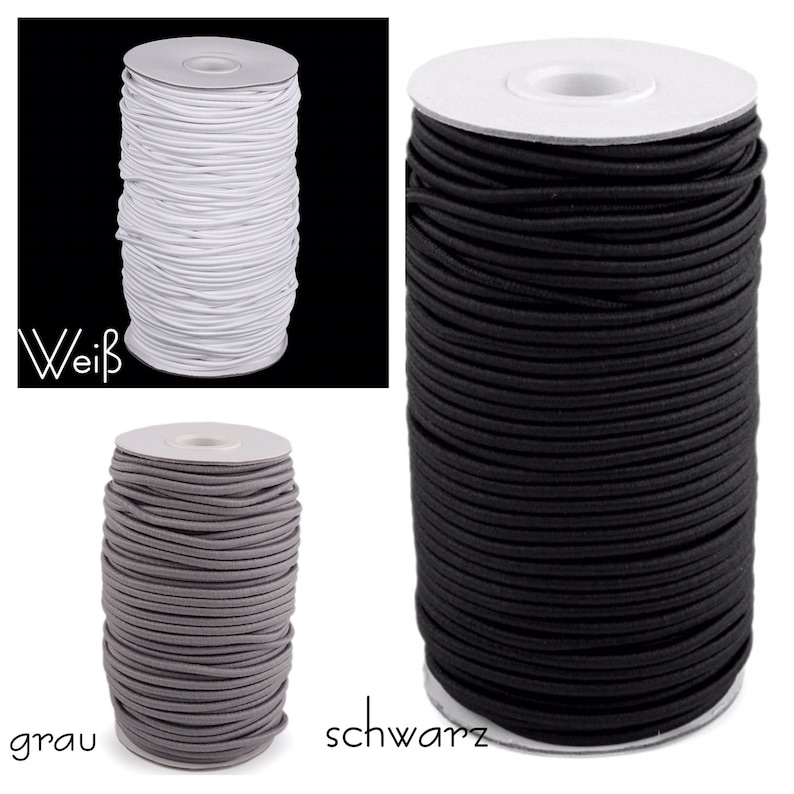 Pu&ograve; includere: Tre bobine di cordoncino elastico in bianco, grigio e nero. Le bobine sono etichettate con "wei&szlig;", "grau" e "schwarz".
