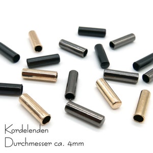 4 metallsnörändar, innerdiameter ca 4 mm, olika färger