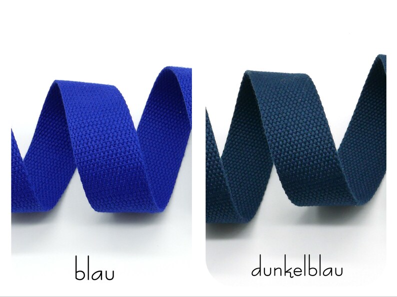 May include: Two samples of woven cotton webbing, one blue and one dark blue. The webbing is folded in a W shape.
