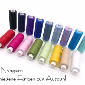 May include: A variety of colors of thread spools, including red, pink, green, yellow, blue, and white. The spools are arranged in a semi-circle on a white surface. The text "Toldi Nähgarn verschiedene Farben zur Auswahl" is visible below the spools.