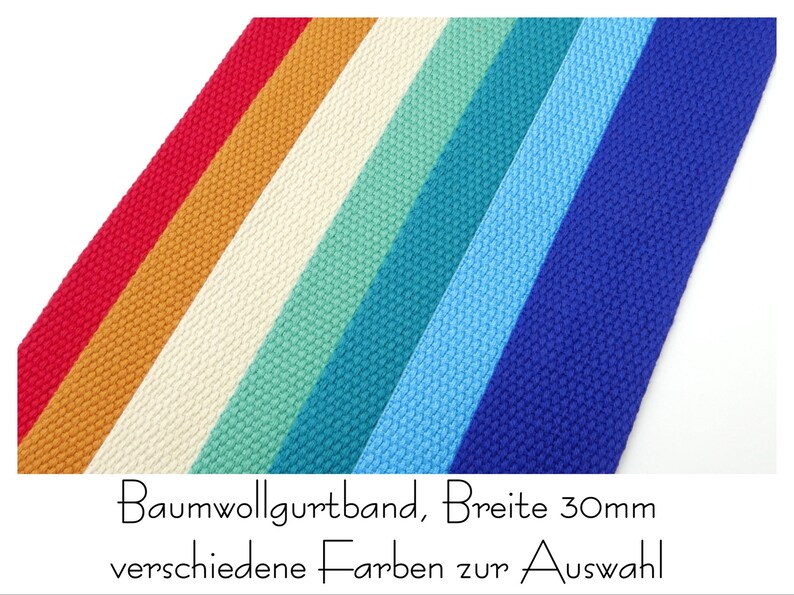 May include: A selection of cotton webbing in various colors, including red, orange, cream, teal, light blue, and dark blue. The webbing is 30mm wide and is labeled "Baumwollgurtband, Breite 30mm verschiedene Farben zur Auswahl".