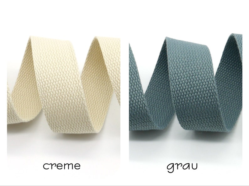 May include: Two rolls of woven cotton webbing, one in cream and one in gray. The webbing is textured and has a subtle sheen.